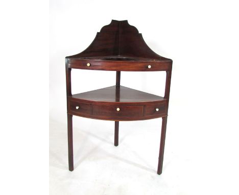 A George lll mahogany corner wash stand, galleried back, pierced upper shelf, lower shelf with a central drawer.  h. 102 cm. 