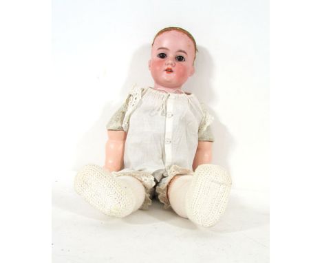 An Armand Marseille bisque head and shouldered doll, model 370, with brown wig, brown sleep eyes, open mouth showing four tee