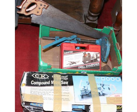 A box lot of tools to include mitre saw, hand saws, drill stand and drill sharpening kit.