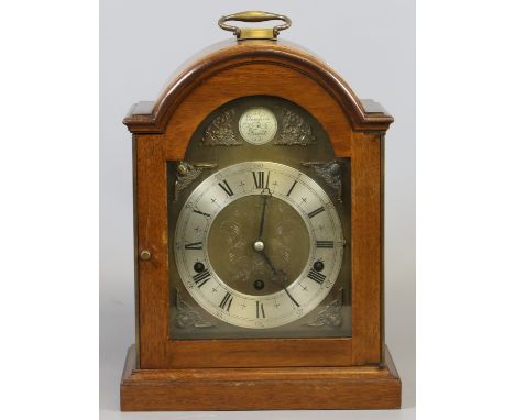A mahogany cased eight day Elliot bracket clock with brass arched dial having silvered chapter ring, Westminster quarter chim