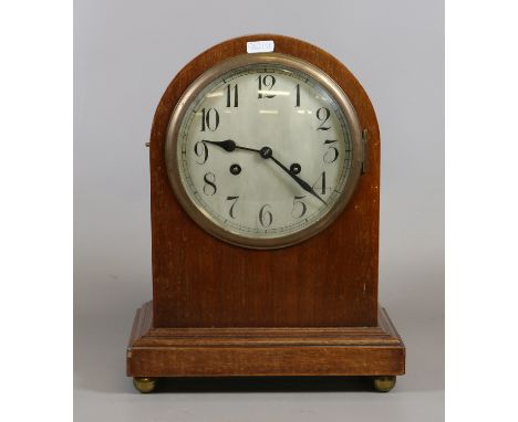 A C19th arch top mantel clock with Arabic numeral dial enclosing twin train movement.