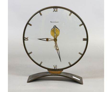 A Jaeger Le Coultre perspex disc shaped clock with floating skeleton movement, 23.5cm high. Condition Report. To be used as a
