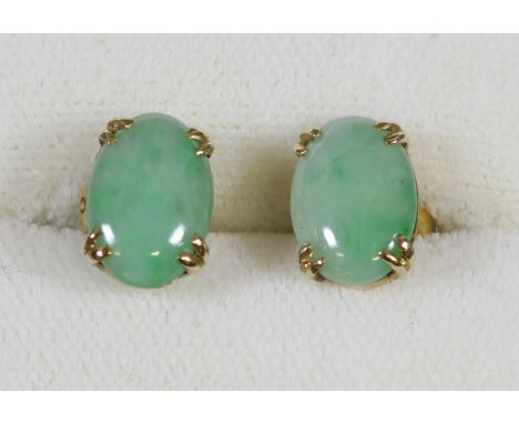 A pair of 9 carat gold and jade earrings of ovoid form