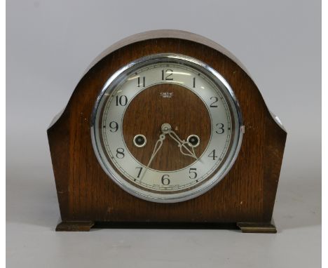 A Smiths Enfield oak cased mantel clock. The Arabic numeral dial encloses eight day two train movement, rear door with origin