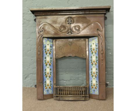 An Art Nouveau steel fire surround inset with Majolica tiles.