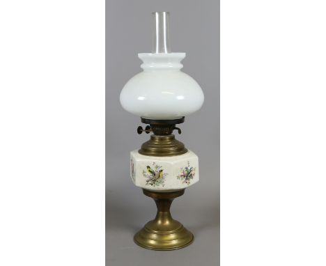 A C20th brass based oil lamp with milchglas shade and printed font depicting birds and foliage.