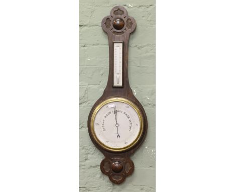 A 1930s carved oak banjo barometer by R & J Beck Limited London.