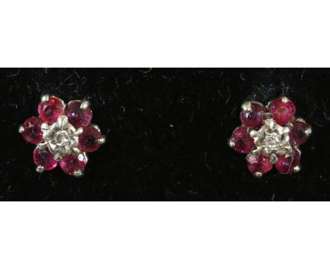 A pair of 9 carat gold ruby and diamond cluster stud earings
