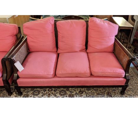 BERGERE SOFA, 163cm x 78cm x 89cm H, Edwardian mahogany with carved detail, double caned and with dark pink cushions. 