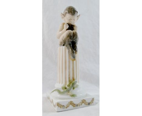 A Royal Copenhagen porcelain figure of a fawn seated on a pillar playing the pipes, with lizard beneath, numbered 1020/433 to