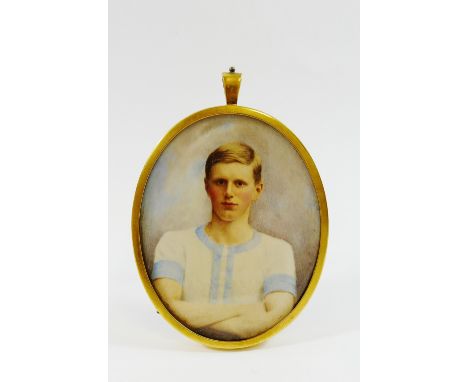 A late Victorian oval portrait miniature on ivory of a young man in a Cambridge University athletic top, housed in gold mount