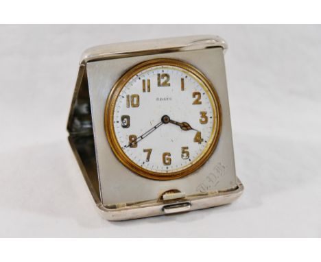 A silver cased folding bedside clock, with eight day movement,  Birmingham 1925 by Adie Bros Ltd, the case with engine turned