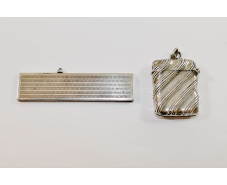 A small silver cased retractable comb with import marks for London 1926, with engine turned decoration, 7.7cm long, and an Ed