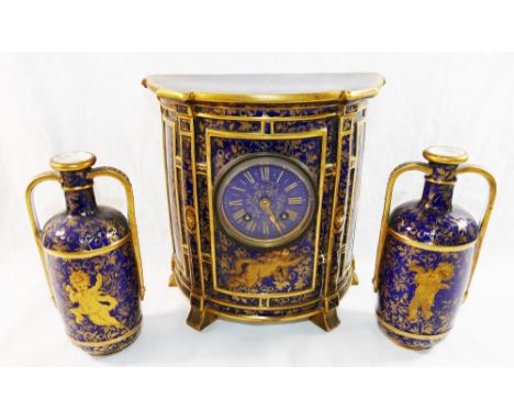 A Victorian Wedgwood bone china cased mantle clock and vase garniture, the cobalt blue ground clock and vases with printed gi