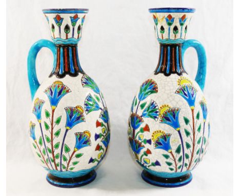 A pair of French Lonwy Pottery ewers, with stylised floral enamel decoration, 25cm high CONDITION REPORT: Please note - Descr
