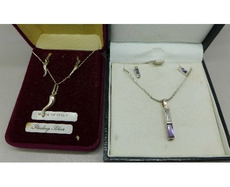 A pair of silver and amethyst earrings and a matching pendant and chain and a pair of silver earrings with a matching pendant