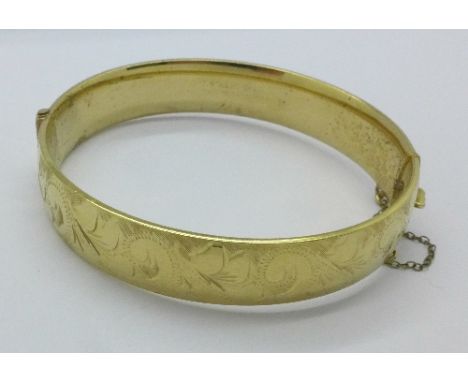 A 9ct rolled gold, half engraved bangle