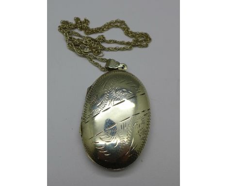 A silver locket and chain, 49mm x 31mm