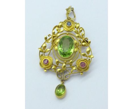 An Edwardian 15ct gold, peridot, ruby and sapphire drop pendant/brooch by Murrle Bennett, width 26mm
