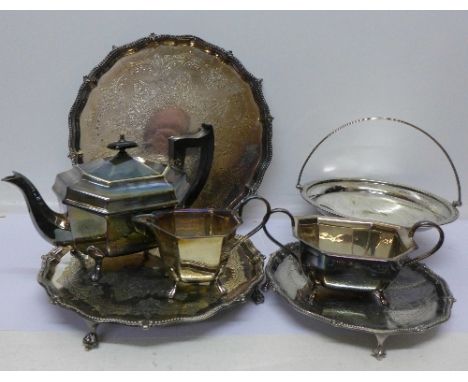 A set of three graduated plated trays, a three piece plated tea service and a plated basket