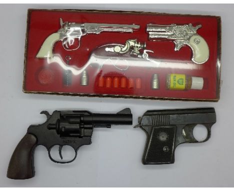 A Pistolet toy gun set and two other toy guns