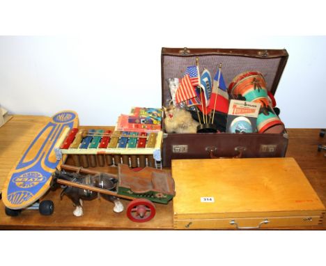 A vintage case with a child's wood working set and other toys and games.