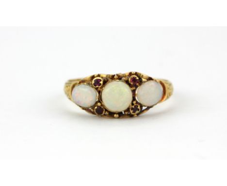 An Edwardian 18ct yellow gold opal and ruby set ring, (M).
