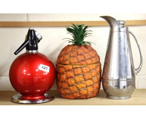 A 1960's pineapple ice bucket, a soda syphon and a chrome backing flask.