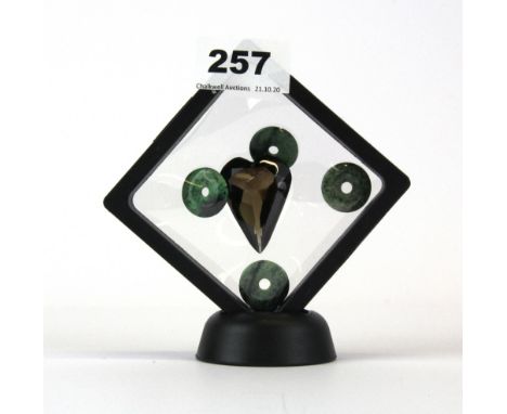 A large heart shaped smokey quartz and four jade disks.