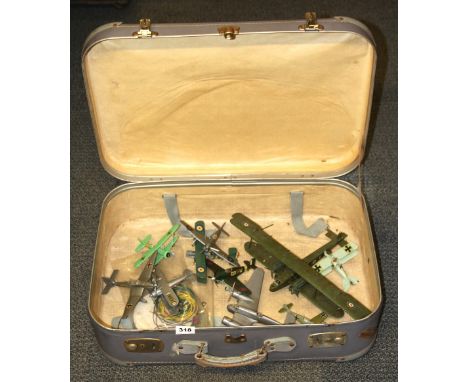 A vintage case containing a collection of plastic model aircraft.