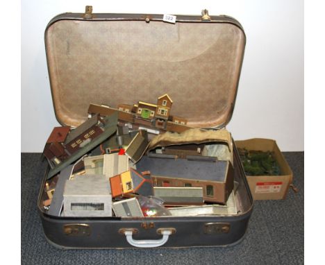 A vintage case containing a quantity of 00 gauge model railway accessories.