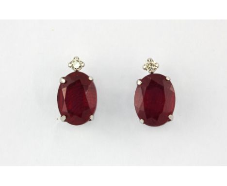 A pair of 18ct white gold (stamped 18k) ruby and diamond set stud earrings, L. 1cm.