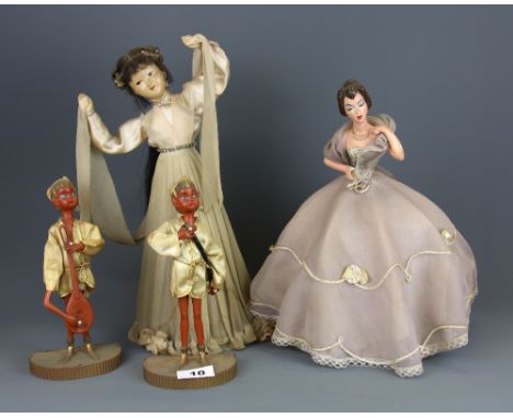 A tin and celluloid musical battery operated dancing girl, together with a 1930's lady light and two celluloid figures, danci