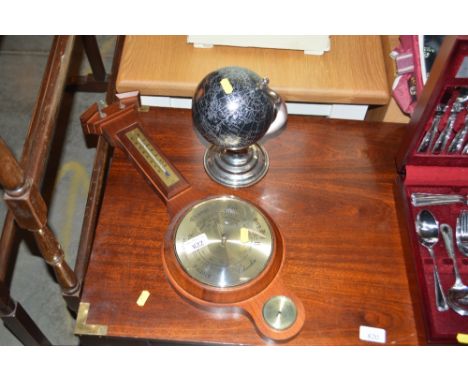 A miniature globe together with a barometer 