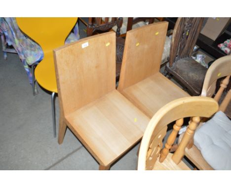 A pair of modern light oak veneered dining chairs 