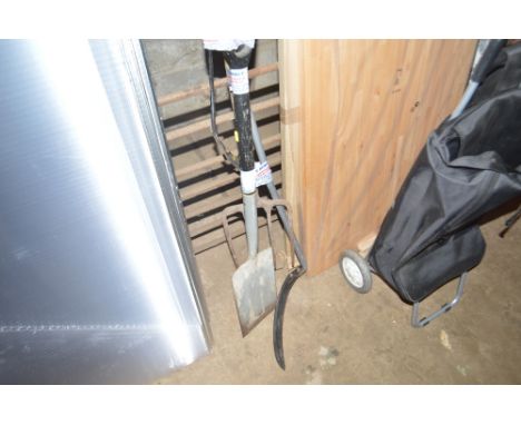 A bundle of long handled gardening tools