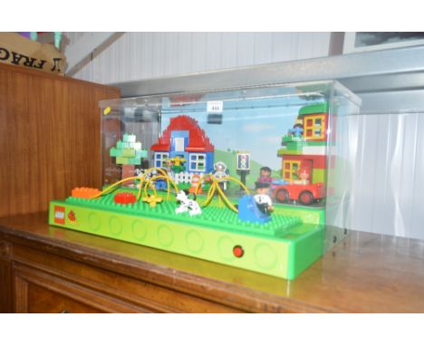 A Lego Duplo retail display box with push button, LED light up box and play figures (on the front, these models can normally 