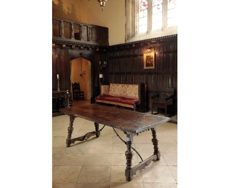 A SPANISH WALNUT CENTRE TABLE, basically late 17th century, with a plain rectangular top on slightly splayed ring-turned balu