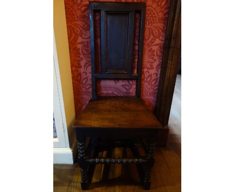 A WILLIAM AND MARY OAK "BACK STOOL" with a panelled rectangular back over a solid seat, on a bobbin-turned underframe, 18" wi