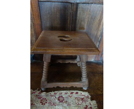 A PAIR OF HISPANIC STYLE JOINED STOOLS with pierced square seats, on splayed bobbin-turned legs joined by squared stretchers,