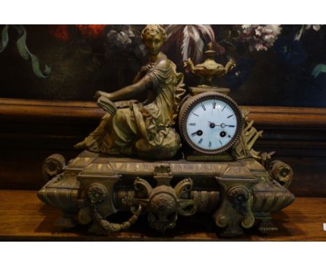 A LOUIS XVI STYLE GILT METAL MANTEL CLOCK with a white enamel dial and a simple bell-striking movement, the case with a recli