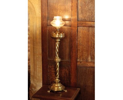 A PAIR OF VICTORIAN BRASS LAMP BASES in the Gothick style with spirally fluted columns and square bases with three paw feet, 