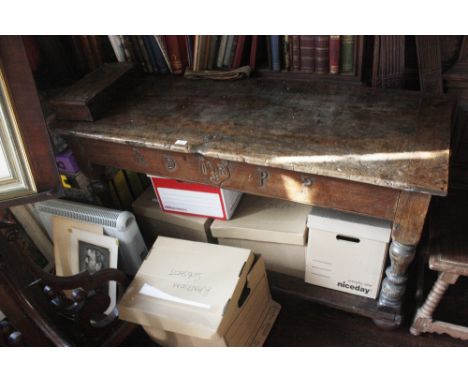 A SMALL REFECTORY TABLE of 17th century design with a well-figured and worn walnut top over a carved frieze incorporating an 
