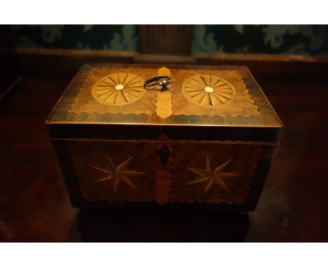 A GEORGE III BURRWOOD AND MARQUETRY TEA CADDY of rectangular form decorated with oval paterae and stars to the lid and front 