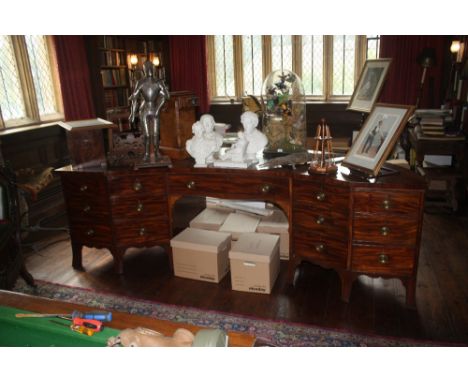 AN UNUSUAL GEORGE III MAHOGANY SIDEBOARD or library cabinet, of concave form, with a crossbanded and boxwood edge top over an