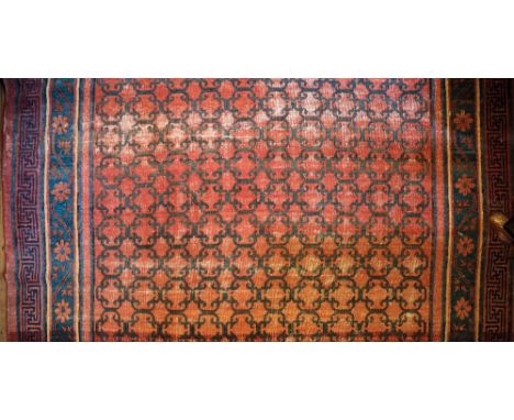 A RARE KHOTAN CARPET, East Turkestan, 18th/19th century, with a continuous field of conjoined geometric medallions with folia