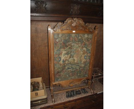 A WALNUT FIRESCREEN in the manner of Daniel Marrow, inset with an 18th century gros and petit point panel worked with figures