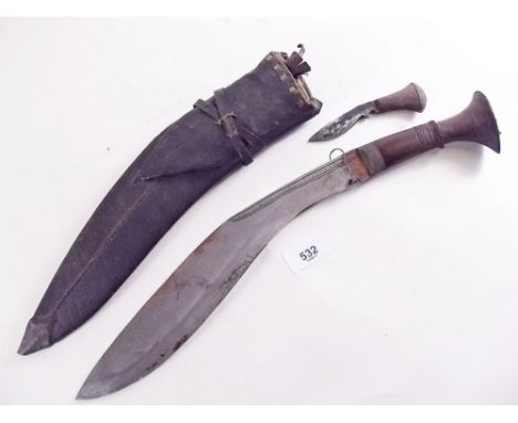 An old Kukri knife in scabbard with two smaller knives