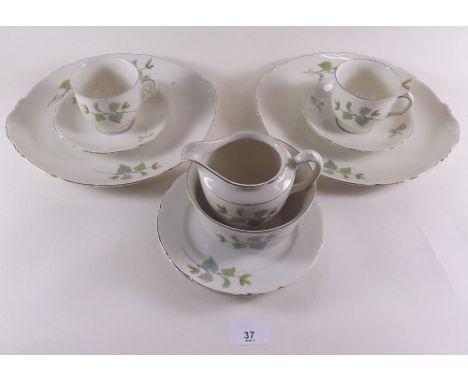 A Royal Ivory tea service decorated catkins comprising eleven cups and saucers, twelve tea plates, jug, sugar and two cake pl