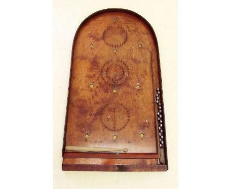 An old bagatelle board with accessories
